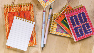 Seasonally colored notebooks arranged on a table.